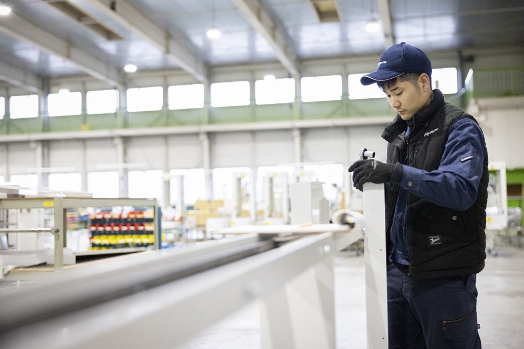 清潔な工場で機械の製造を行う社員