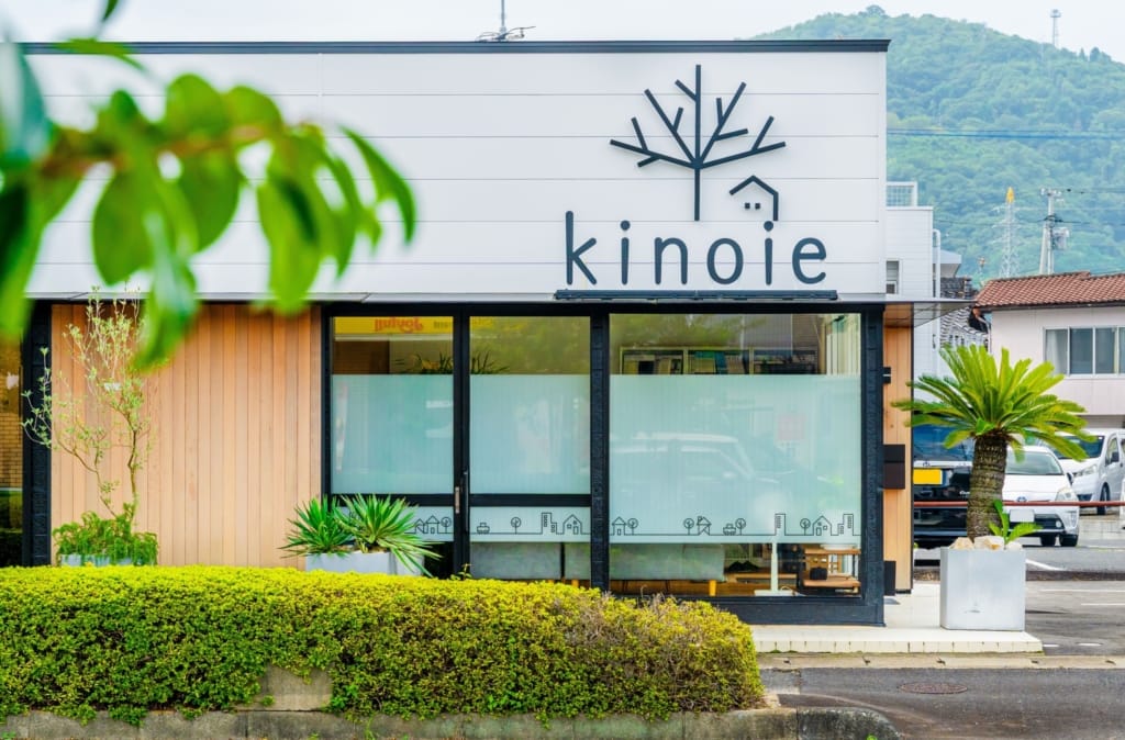 岡山県津山市にある株式会社キノイエのオフィスの外観。白い壁に黒い「kinoie」のロゴが見える。