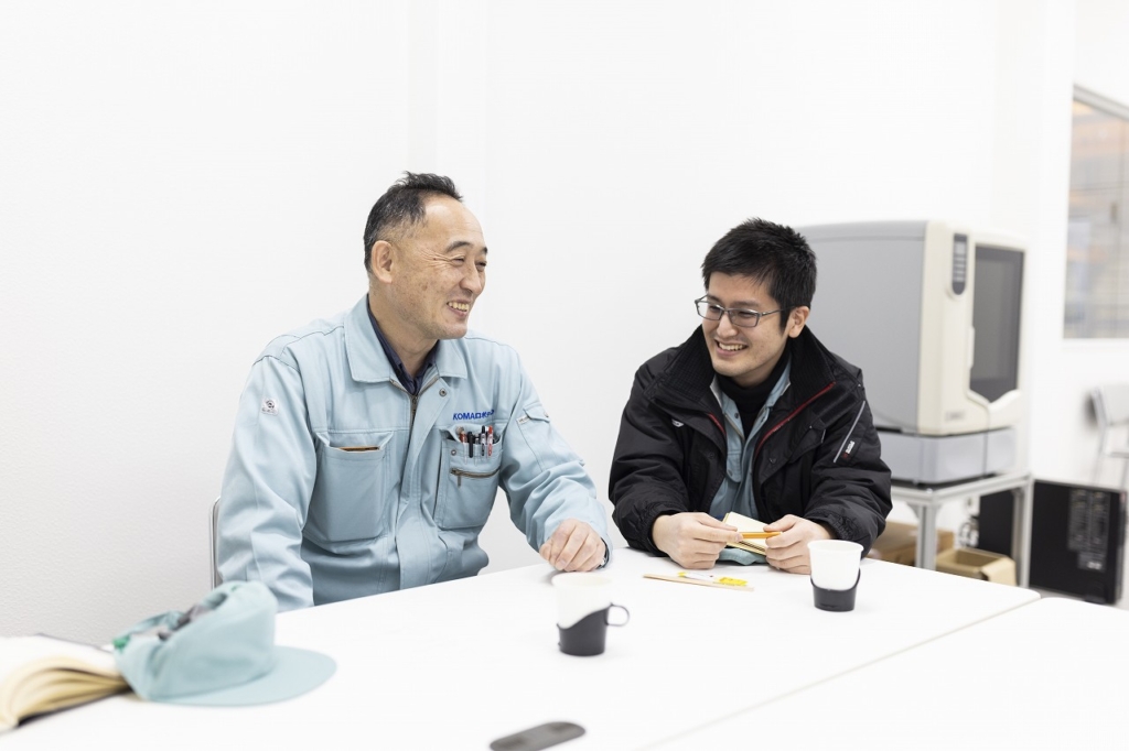 社長と社員が笑いながら話し合っている